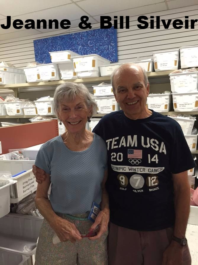 Volunteers working together at tables sorting medical items