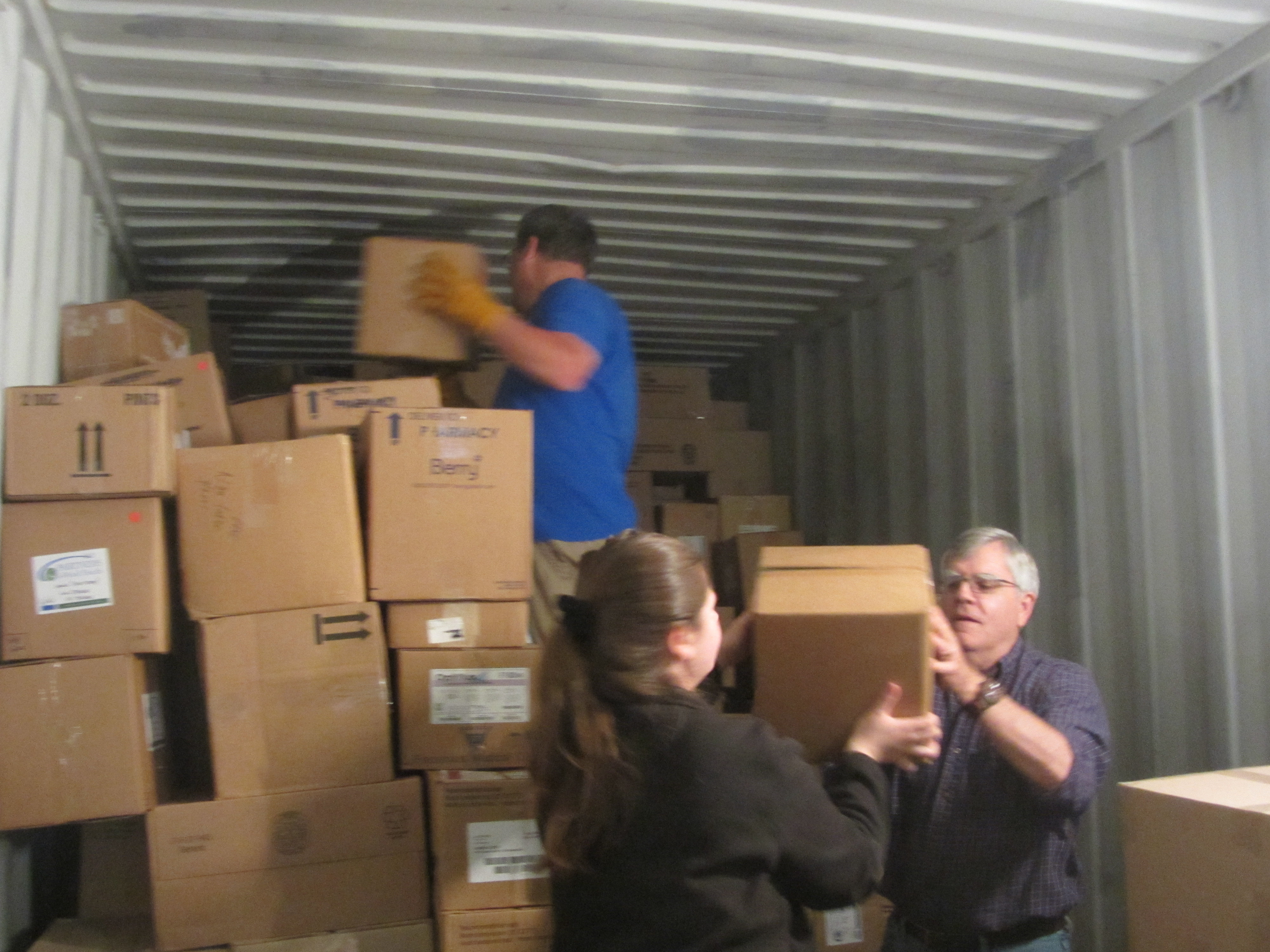 Group of volunteers packing boxes of medical supplies