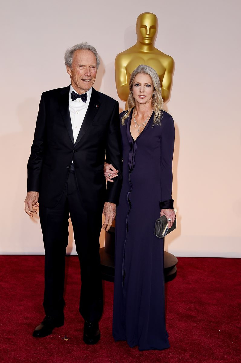 Director Clint Eastwood and Christina Sandera attend the 87th Annual Academy Awards on February 22, 2015