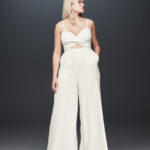 Bride looking away in spaghetti strap bridal jumpsuit, Fame and Partners x David's Bridal collection