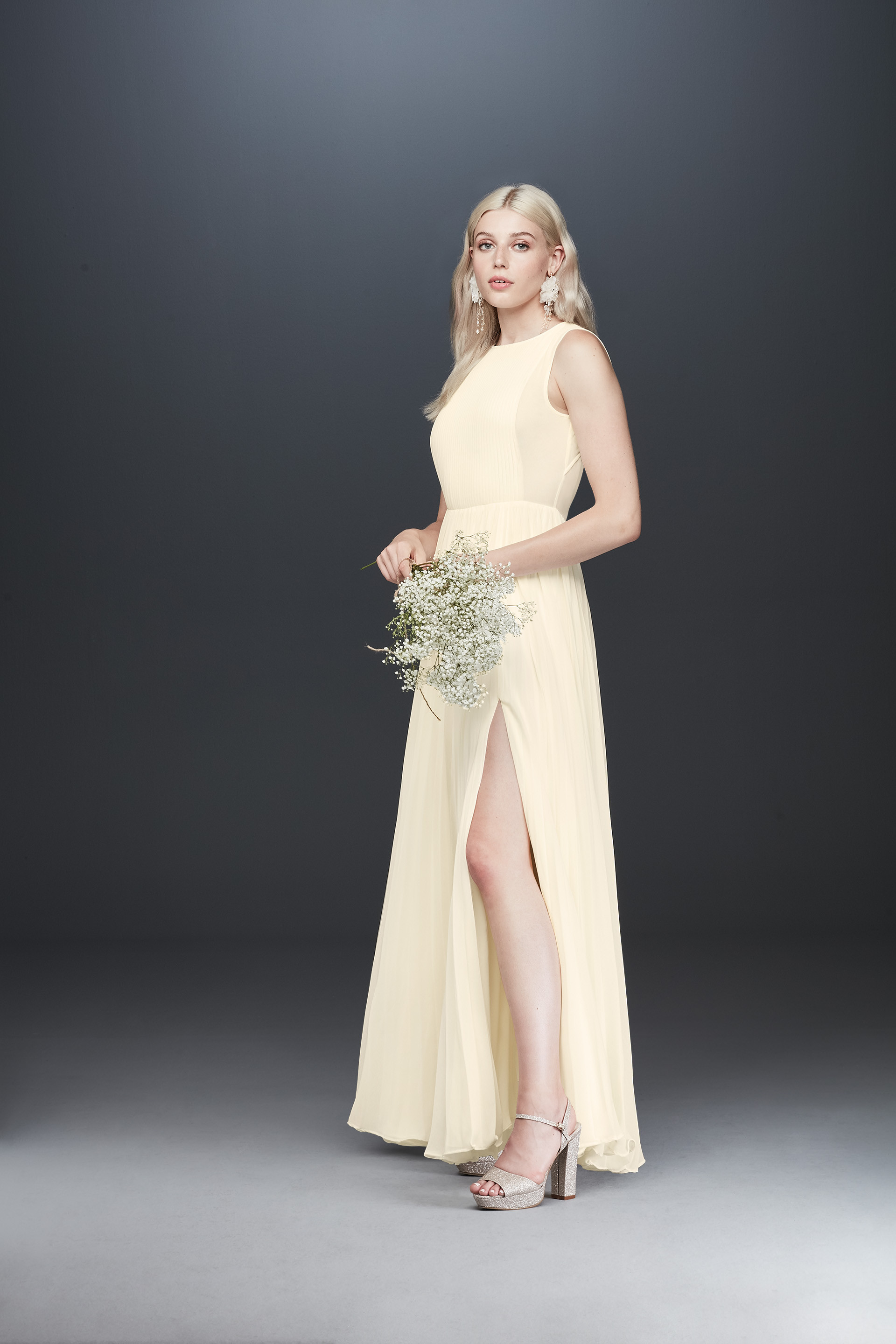 Bride holding flower in high neck long wedding dress with skirt slit, Fame and Partners elegant bridal gowns