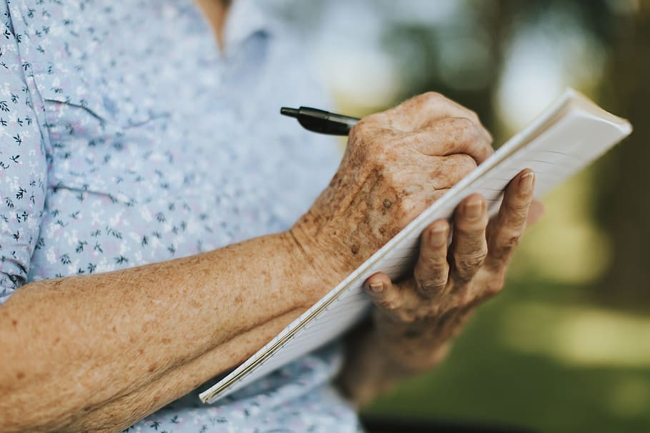 alt text: A care coordinator assisting a senior with paperwork.