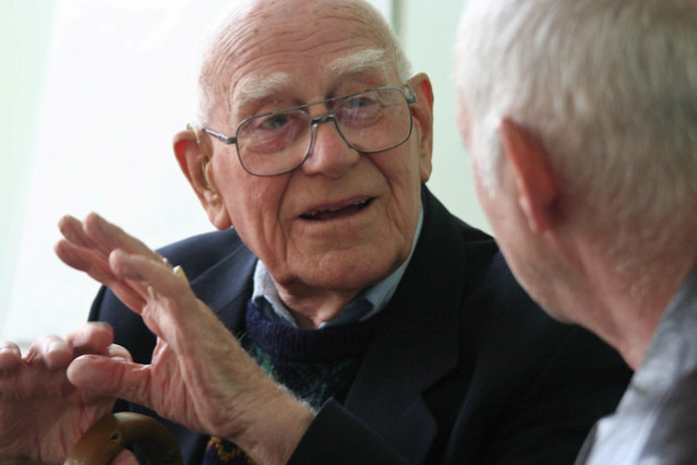 alt text: A volunteer engaging in conversation with a senior.