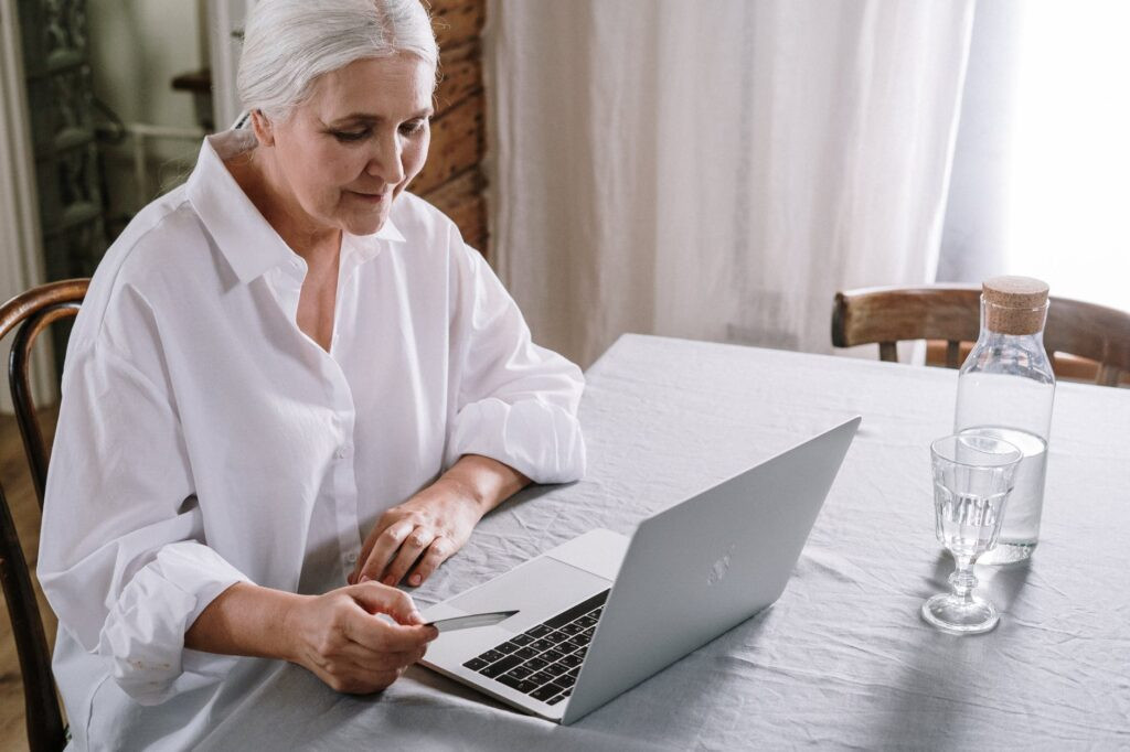 alt text: A senior using a computer to access online resources.