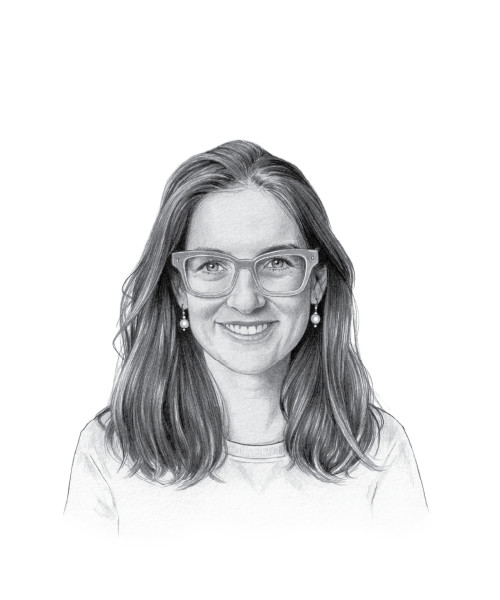 A person smiling while working on a laptop, alt text: Successful SSI recipient working from home