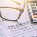 Glasses and Calculator on a 1040 Tax Document