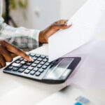 Calculator and holding a paper