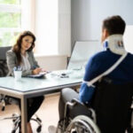 Person working on a laptop while receiving disability benefits, illustrating the concept of earned income
