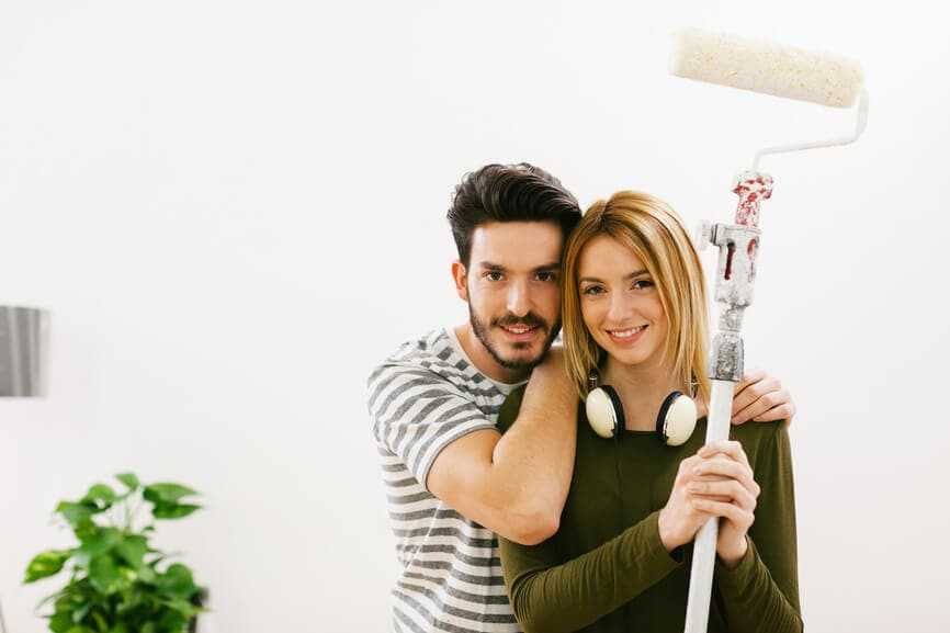 Couple painting the house