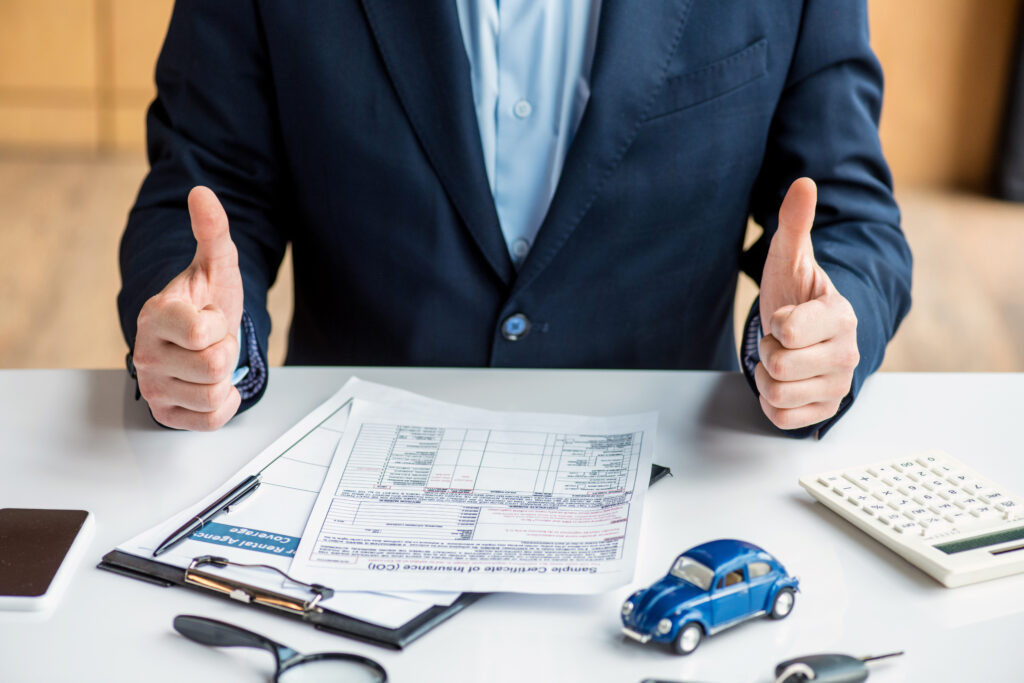 Cropped View of Man Showing Thumbs Up, symbolizing approval for a car loan