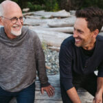 Father helping his son understand financial documents at home