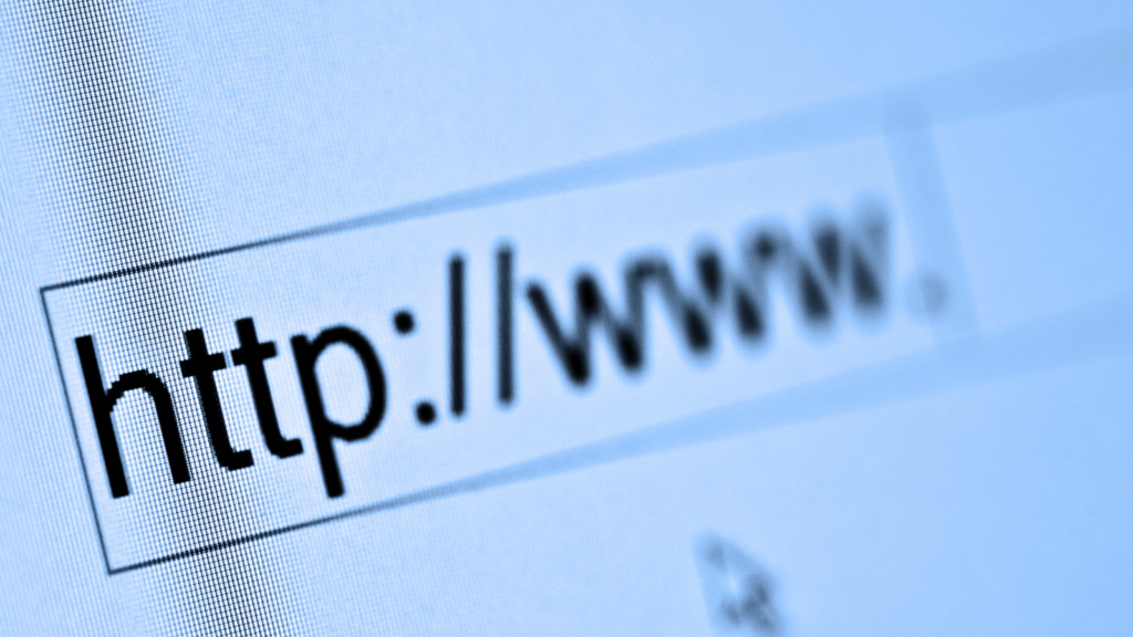 A person typing the initial part of a website URL, “https://www.”.