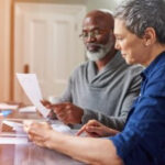 An older couple reviewing their SSA-1099 form to understand their social security benefits