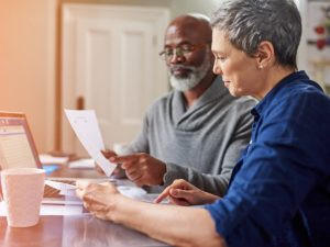 An older couple reviewing their SSA-1099 form to understand their social security benefits