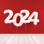 2024 on single white balloons against red wall