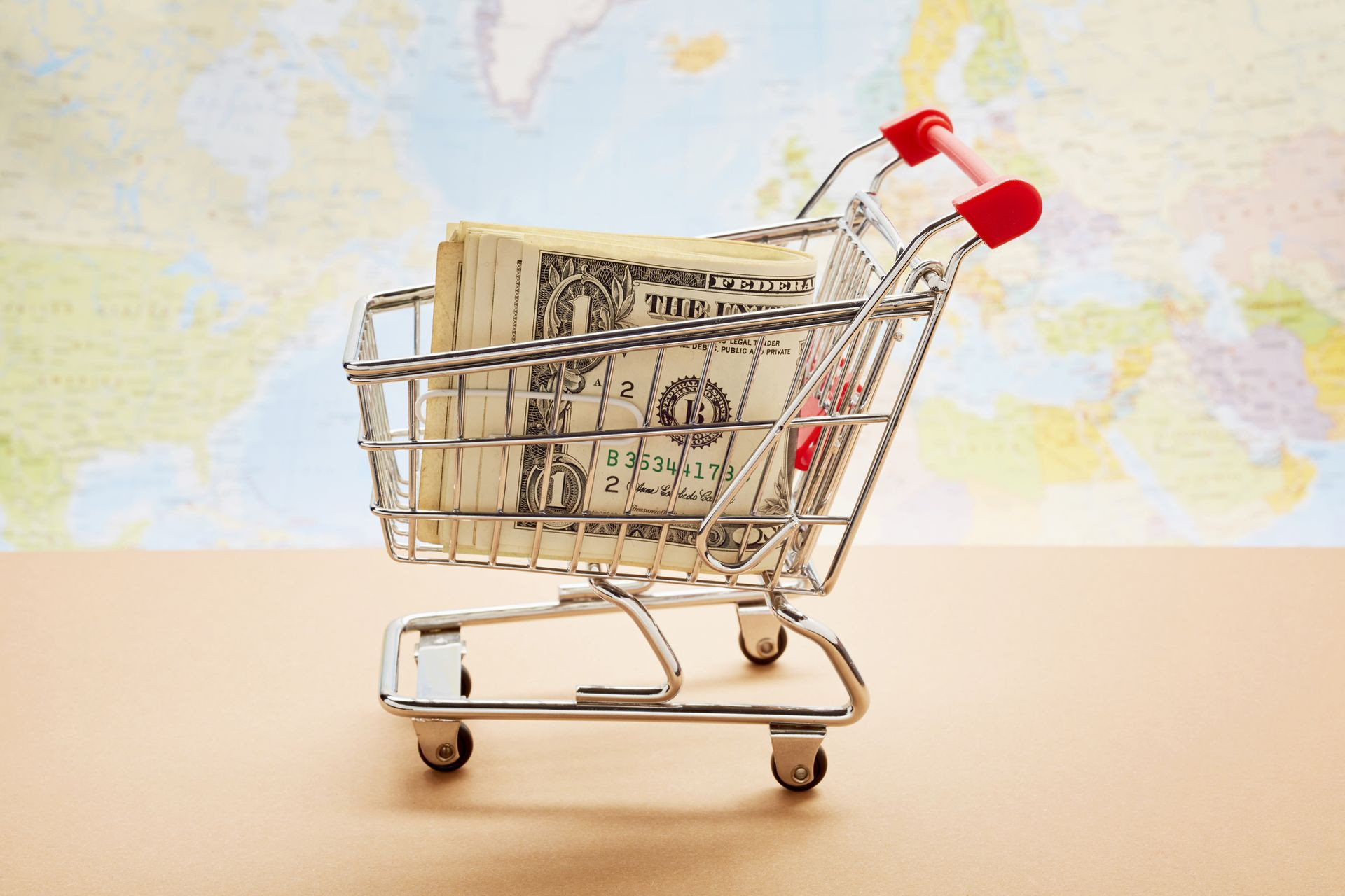 Still life of a small shopping cart with  USD bills symbolizing no sales tax