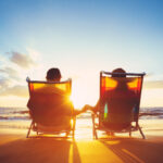 Retired couple sitting on a bench, enjoying their investment income