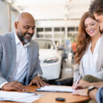 Man checks credit score on laptop signifying importance of credit score for car loans