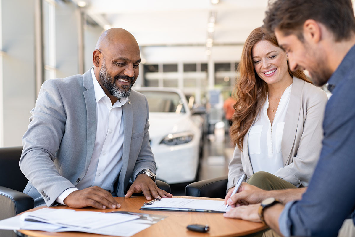 Man checks credit score on laptop signifying importance of credit score for car loans