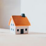 Little model house on a table indicating property taxes