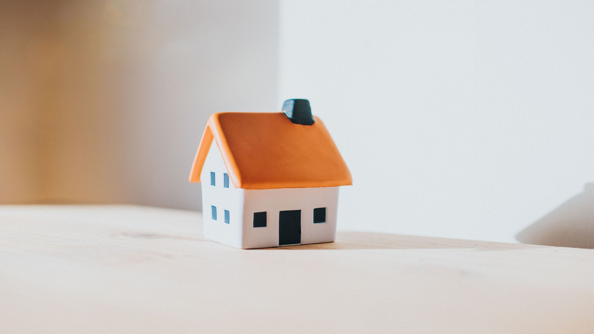 Little model house on a table indicating property taxes