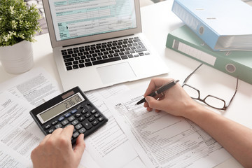 Father Filling Taxes at Desk