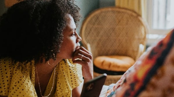Thinking woman deciding between critical illness and income protection