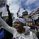People protesting against flat tax in Illinois, advocating for progressive taxation