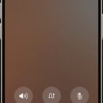The merge calls button in the lower left corner of the iPhone screen