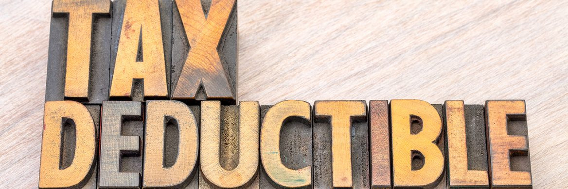 Wooden blocks spell out “Tax Deductible