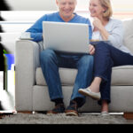 Older couple looking at retirement plans on a laptop