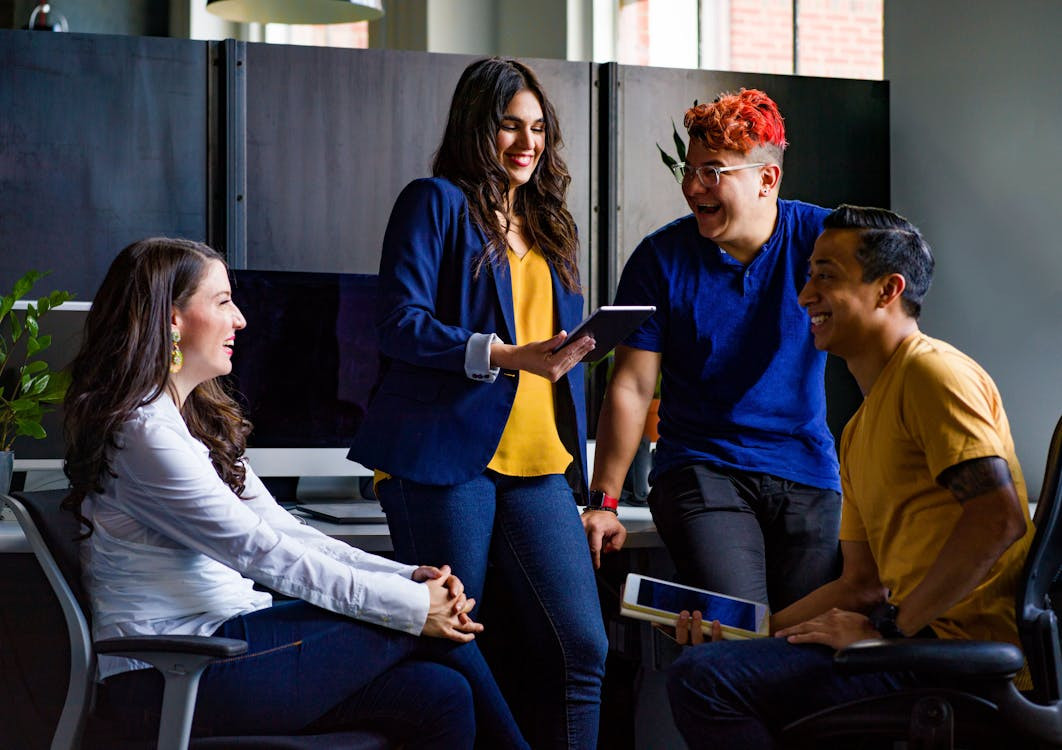 Young women using laptop in creative office.