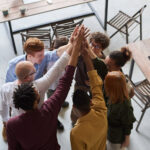 Two businesspeople shaking hands in a modern office, representing successful business partnerships and income generation