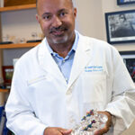 Dr. Jantana posing for photo with anatomy model