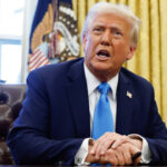American President, Donald Trump, at his office desk